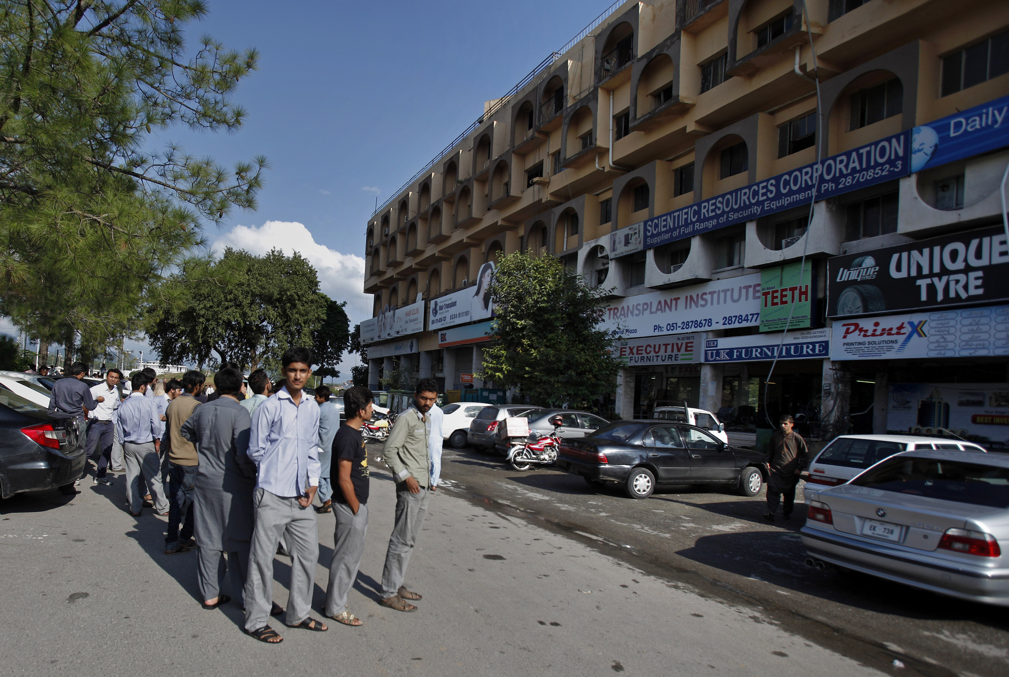 People stand outside their offices after a severe earthquake is felt in Islamabad, Pakistan, Monday (Photo: AP) People stand outside their offices after a severe earthquake is felt in Islamabad, Pakistan, Monday (Photo: AP)